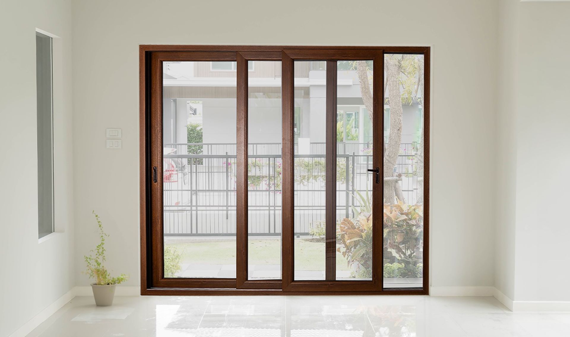 Wood-grain finish UPVC sliding doors against a white wall, blending classic elegance with modern functionality.