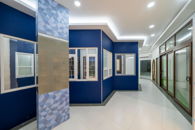 A modern showroom displaying various styles of windows and doors, including sliding doors, casement windows, and more.